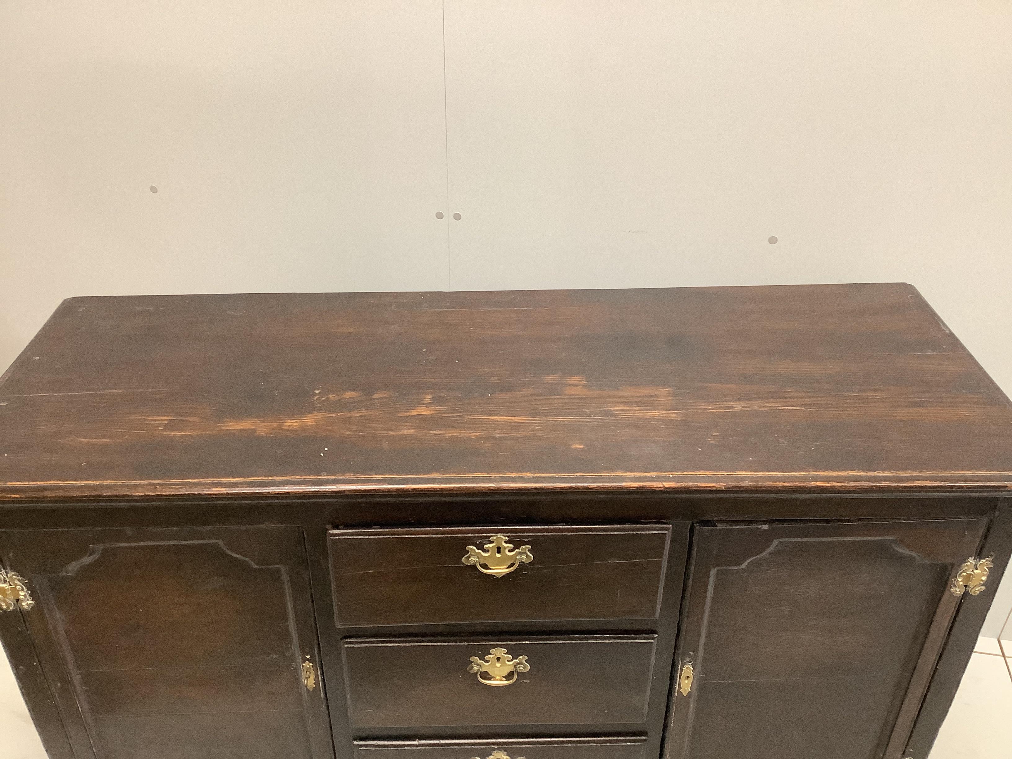 An 18th century sideboard of small proportions raised on bracket supports, width 140cm, depth 50cm, height 87cm